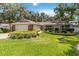 Charming single-story home with a well-manicured front yard, beautiful landscaping, and a welcoming entrance with a two-car garage at 205 Stevenage Dr, Longwood, FL 32779