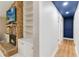 Hallway featuring a stone fireplace, built-in shelves, white walls, and recessed lighting at 205 Stevenage Dr, Longwood, FL 32779