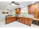 Charming kitchen featuring wooden cabinets, granite countertops, stainless appliances, and tile flooring at 205 Stevenage Dr, Longwood, FL 32779
