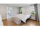 Bright main bedroom boasts stylish decor, wood floors, and ensuite bathroom with soaking tub at 205 Stevenage Dr, Longwood, FL 32779