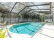 Inviting screened-in pool with sun deck and ladder, creating a private outdoor oasis for relaxation and recreation at 205 Stevenage Dr, Longwood, FL 32779