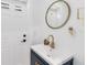 Stylish powder room with an oval mirror, a modern vanity with gold fixtures, and crisp white walls at 205 Stevenage Dr, Longwood, FL 32779