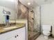 Bathroom with granite countertop, sink, mirror, tiled shower, and toilet at 2055 S Atlantic Ave # 1410, Daytona Beach Shores, FL 32118