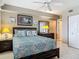 Cozy bedroom with ceiling fan, bedside tables with lamps, dresser, and closet at 2055 S Atlantic Ave # 1410, Daytona Beach Shores, FL 32118