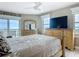 Bedroom featuring a wooden bed frame and dresser with a television and balcony at 2055 S Atlantic Ave # 1410, Daytona Beach Shores, FL 32118