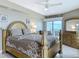 Bedroom featuring a wooden bed frame and dresser with a balcony at 2055 S Atlantic Ave # 1410, Daytona Beach Shores, FL 32118