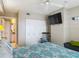 Bedroom with closet, television, chair, bed, and en-suite bathroom at 2055 S Atlantic Ave # 1410, Daytona Beach Shores, FL 32118