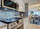 Bright kitchen with granite countertops, modern appliances, and beautiful backsplash at 2055 S Atlantic Ave # 1410, Daytona Beach Shores, FL 32118