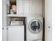 Convenient laundry room with washer, dryer and storage cabinets at 2055 S Atlantic Ave # 1410, Daytona Beach Shores, FL 32118