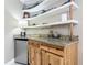 Mini bar featuring knotty pine cabinets, granite countertops, shelving, and a mini refrigerator at 2055 S Atlantic Ave # 1410, Daytona Beach Shores, FL 32118