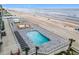 Stunning aerial view of a beachfront pool and deck area at 2055 S Atlantic Ave # 1410, Daytona Beach Shores, FL 32118