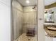 Updated shower featuring pebble floor, light neutral tile and frameless glass surround at 2055 S Atlantic Ave # 1410, Daytona Beach Shores, FL 32118