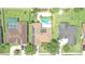 Aerial view of house with heart shaped pool, solar panels, well manicured yard and mature trees at 2406 Sweetwater Blvd, St Cloud, FL 34772