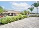 Spacious brick paved backyard with privacy hedge, palm trees, and patio furniture, perfect for outdoor living at 2406 Sweetwater Blvd, St Cloud, FL 34772