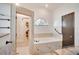Modern bathroom features a soaking tub, separate tiled shower, and updated fixtures at 2406 Sweetwater Blvd, St Cloud, FL 34772