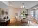 Elegant dining room with designer chandelier, decorative artwork, and seating for six at 2406 Sweetwater Blvd, St Cloud, FL 34772