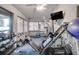 Home gym featuring weightlifting equipment, free weights, and a flat screen television at 2406 Sweetwater Blvd, St Cloud, FL 34772