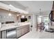 Open kitchen with stainless steel dishwasher, granite countertops and a cozy breakfast nook at 2406 Sweetwater Blvd, St Cloud, FL 34772