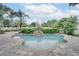 Resort-style pool area featuring a waterfall feature, lush landscaping, and ample deck space at 2406 Sweetwater Blvd, St Cloud, FL 34772