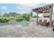 Backyard pool with waterfall feature and covered patio area, perfect for relaxing and entertaining at 2406 Sweetwater Blvd, St Cloud, FL 34772