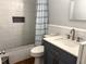 Cozy bathroom featuring tiled walls, a shower with patterned curtain, and modern vanity with a white countertop at 2515 Marlboro St, Orlando, FL 32806