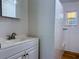 Bright bathroom featuring tiled walls, a sink with vanity, and a shower area, designed for comfort and functionality at 2515 Marlboro St, Orlando, FL 32806