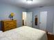 Bright bedroom with a bed, wooden dresser, and a doorway leading to another room, creating an open and inviting space at 2515 Marlboro St, Orlando, FL 32806