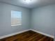 Cozy bedroom with hardwood floors, neutral walls, and a large window for natural light at 2515 Marlboro St, Orlando, FL 32806