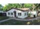 Charming single-story home with stucco exterior, brick walkway, and lush landscaping at 2515 Marlboro St, Orlando, FL 32806