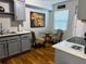 Well-lit kitchen with gray cabinets, modern appliances, and a cozy dining area at 2515 Marlboro St, Orlando, FL 32806