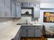 Updated kitchen with gray cabinets, quartz countertops, and stainless steel appliances at 2515 Marlboro St, Orlando, FL 32806