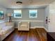 Inviting living room featuring hardwood floors, cream-colored couches, natural lighting, and a vintage-style floor lamp at 2515 Marlboro St, Orlando, FL 32806