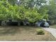 Charming single-story home featuring a large, tree-filled front yard and a paved driveway at 2645 Ne 44Th St, Ocala, FL 34479