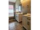 Well-lit bathroom featuring dual vanities with modern fixtures and tile flooring at 2817 Moultrie Creek Dr, Kissimmee, FL 34743