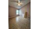 Empty bedroom with tile floors features a ceiling fan and window at 2817 Moultrie Creek Dr, Kissimmee, FL 34743