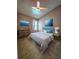 Bright bedroom features tile flooring, ceiling fan and beach themed decor at 2817 Moultrie Creek Dr, Kissimmee, FL 34743