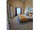 Bright bedroom features tile flooring, a ceiling fan, and a large window at 2817 Moultrie Creek Dr, Kissimmee, FL 34743