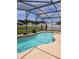 Sparkling pool surrounded by lush landscaping within a screened enclosure at 2817 Moultrie Creek Dr, Kissimmee, FL 34743