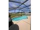 Backyard pool and patio surrounded by a screened enclosure at 2817 Moultrie Creek Dr, Kissimmee, FL 34743