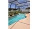 Sparkling pool surrounded by lush landscaping within a screened enclosure at 2817 Moultrie Creek Dr, Kissimmee, FL 34743