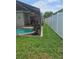 Green lawn with a pool and a white fence at 2817 Moultrie Creek Dr, Kissimmee, FL 34743