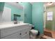 Bright bathroom featuring a vanity with modern fixtures and a separate toilet area at 303 Mariana Way, Kissimmee, FL 34758