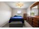 Bedroom features natural light, a ceiling fan, and neutral carpet and a dresser at 303 Mariana Way, Kissimmee, FL 34758