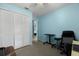 Bedroom with closet and neutral carpet features blue walls and a ceiling fan at 303 Mariana Way, Kissimmee, FL 34758