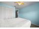 Cozy bedroom with neutral carpet and ceiling fan; blue walls and closet at 303 Mariana Way, Kissimmee, FL 34758