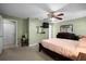Spacious bedroom featuring a ceiling fan, carpeted floors and neutral-colored walls at 303 Mariana Way, Kissimmee, FL 34758