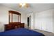 Bedroom features neutral carpet, a closet, a ceiling fan, and a dresser at 303 Mariana Way, Kissimmee, FL 34758