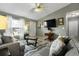 Inviting living room with modern furnishings, a ceiling fan, and neutral paint at 303 Mariana Way, Kissimmee, FL 34758
