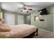 Large main bedroom features carpet, a TV, and multiple closets and ceiling fan at 303 Mariana Way, Kissimmee, FL 34758