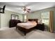 Spacious main bedroom with carpet, ceiling fan and dresser; large window lets in natural light at 303 Mariana Way, Kissimmee, FL 34758